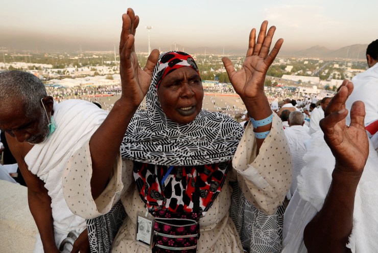 A Muslim pilgrim prays as she gathers with others on Mount Mercy on the plains of Arafat during the annual haj pilgrimage, outside the holy city of Mecca